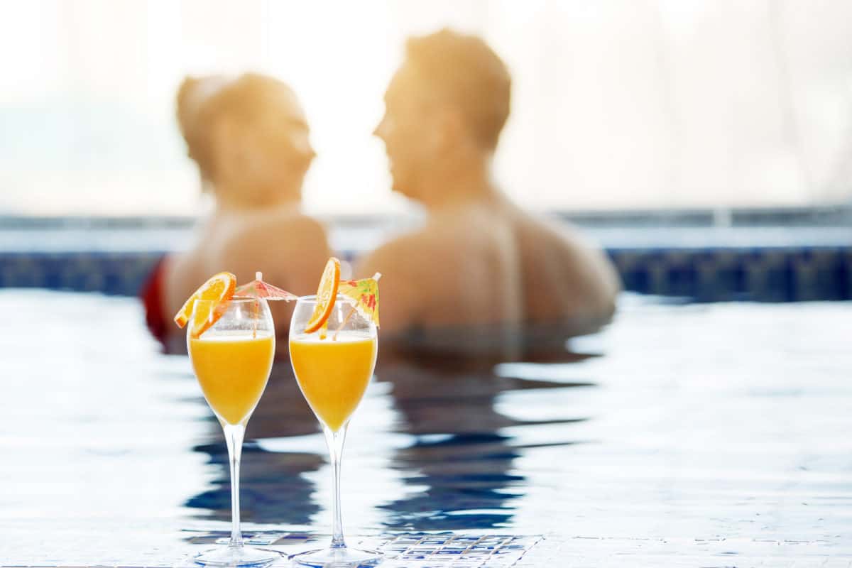 Depending upon your liquid net worth, you may feel like this couple enjoying champagne at sunset.